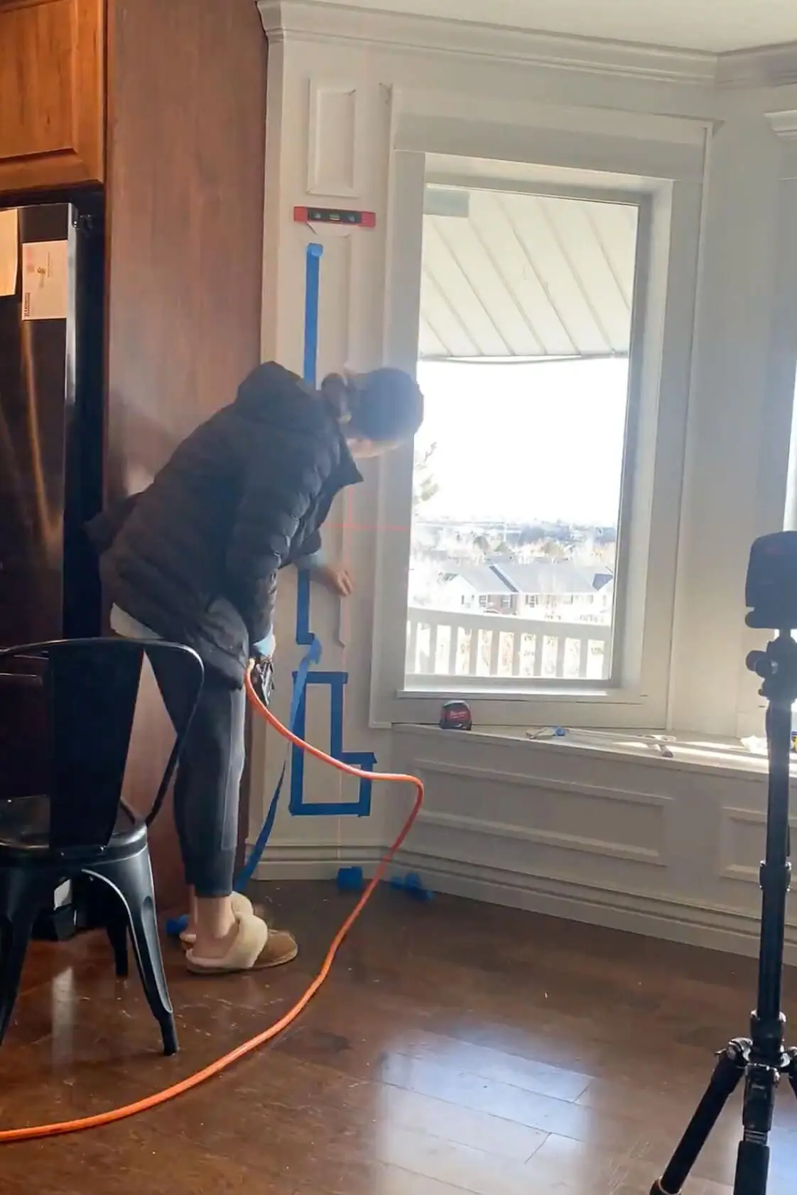 Installing picture frame molding around a bay window.